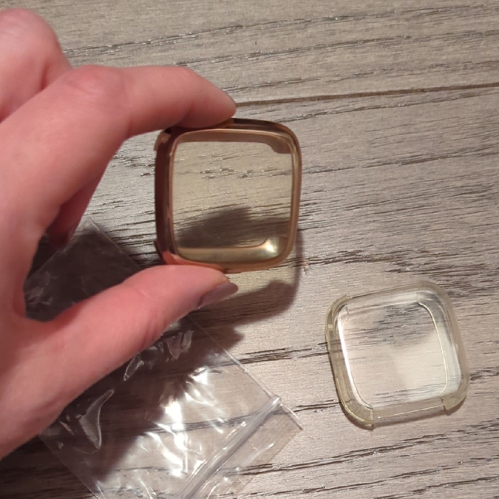 two FitBit Versa Protective Cases-gold And Clear